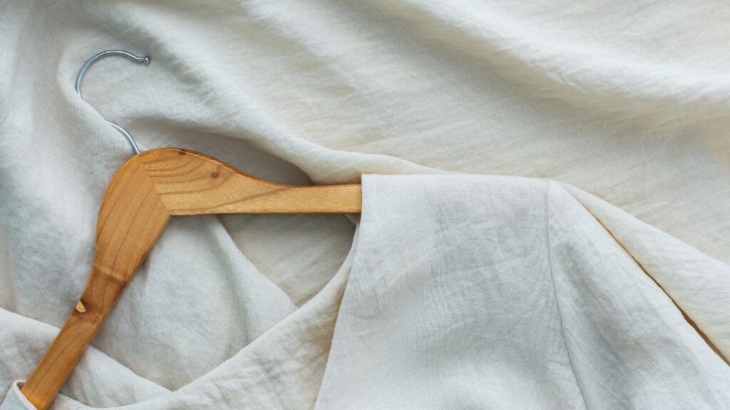 Sustainable medical scrub made out of eco-friendly materials on a clothing hanger.