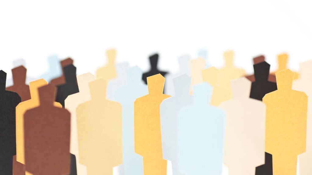 Paper cutout silhouettes of people in diverse colors.