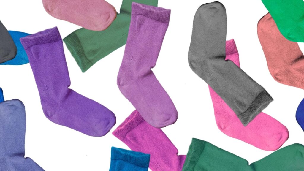 Colorful compression socks scattered on a white background.