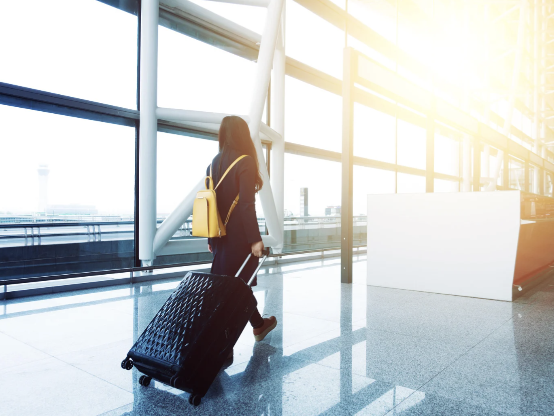 Travel nurse carries bag in airport